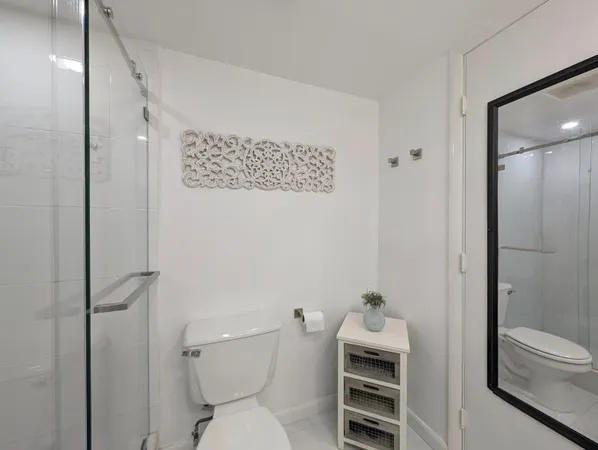 a bathroom with a toilet and a shower