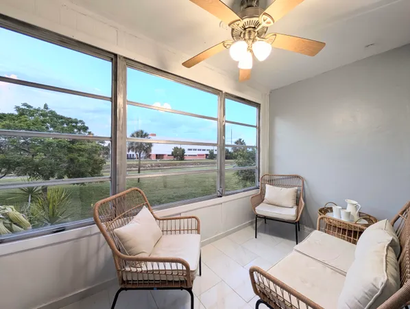 a balcony with couple of chairs and a couch