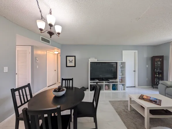 a view of a dining room with furniture and a flat screen tv