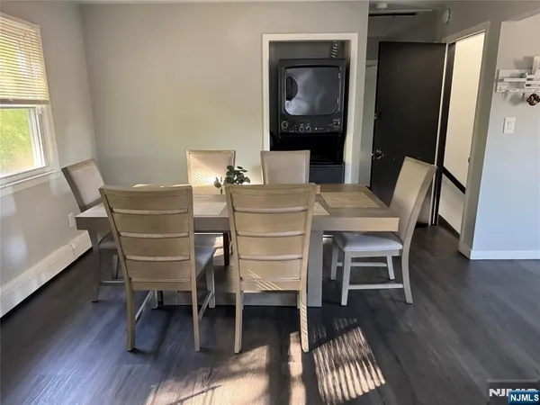 a dining room with furniture and wooden floor