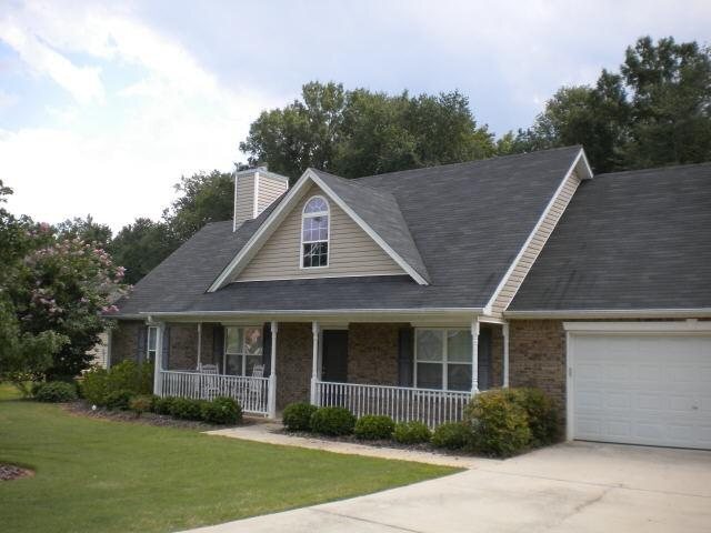171 Windpher Ridge Hampton, GA 30228 - Photo 1 of 1 a front view of a house with a garden