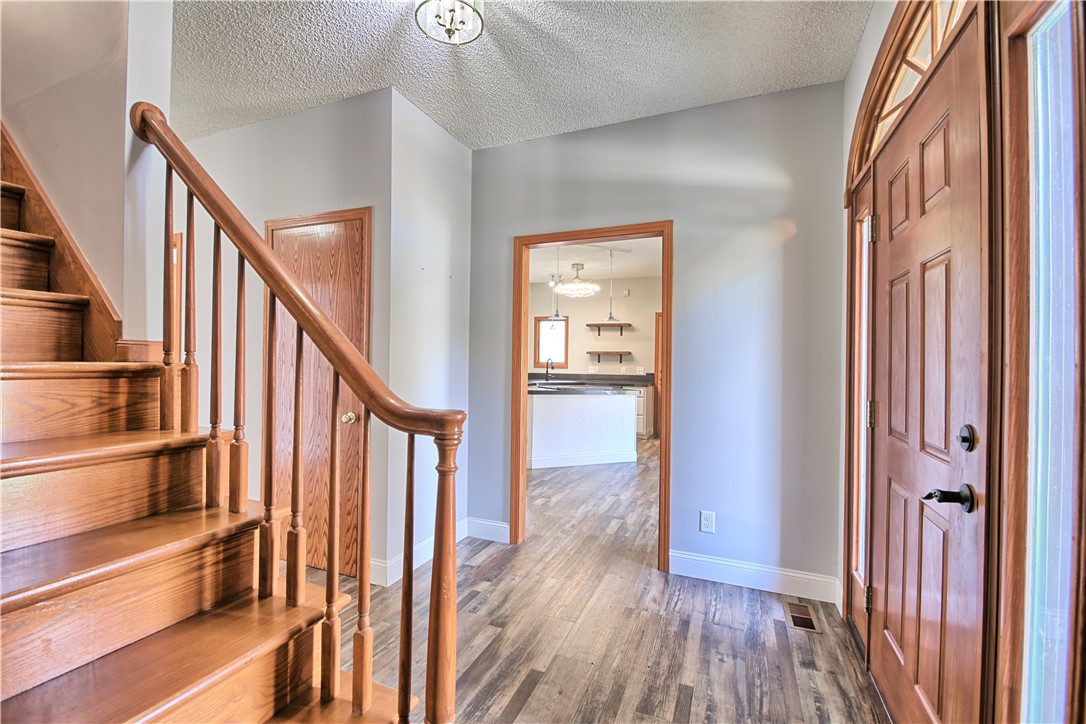 8711 Nicole Lane Springboro, OH 45066 - Photo 7 of 87 The bright entry welcomes you with wood flooring and a beautiful wooden staircase.