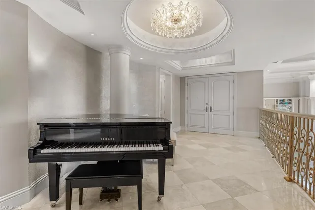 a room with a table chairs and kitchen view