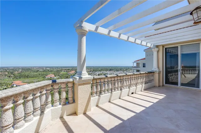 a view of a balcony with a large window and wooden floor