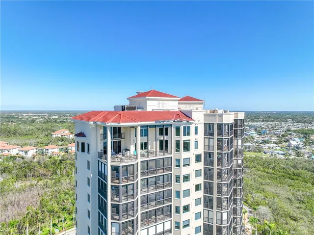 a view of a large building with a yard and balcony