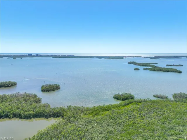 an aerial view of a houses with a lake view