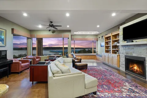a living room with fireplace furniture and a flat screen tv