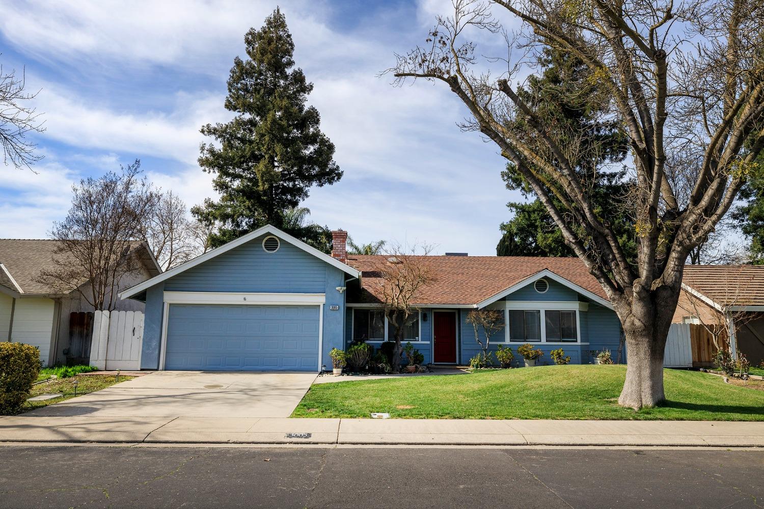 a front view of a house with a garden