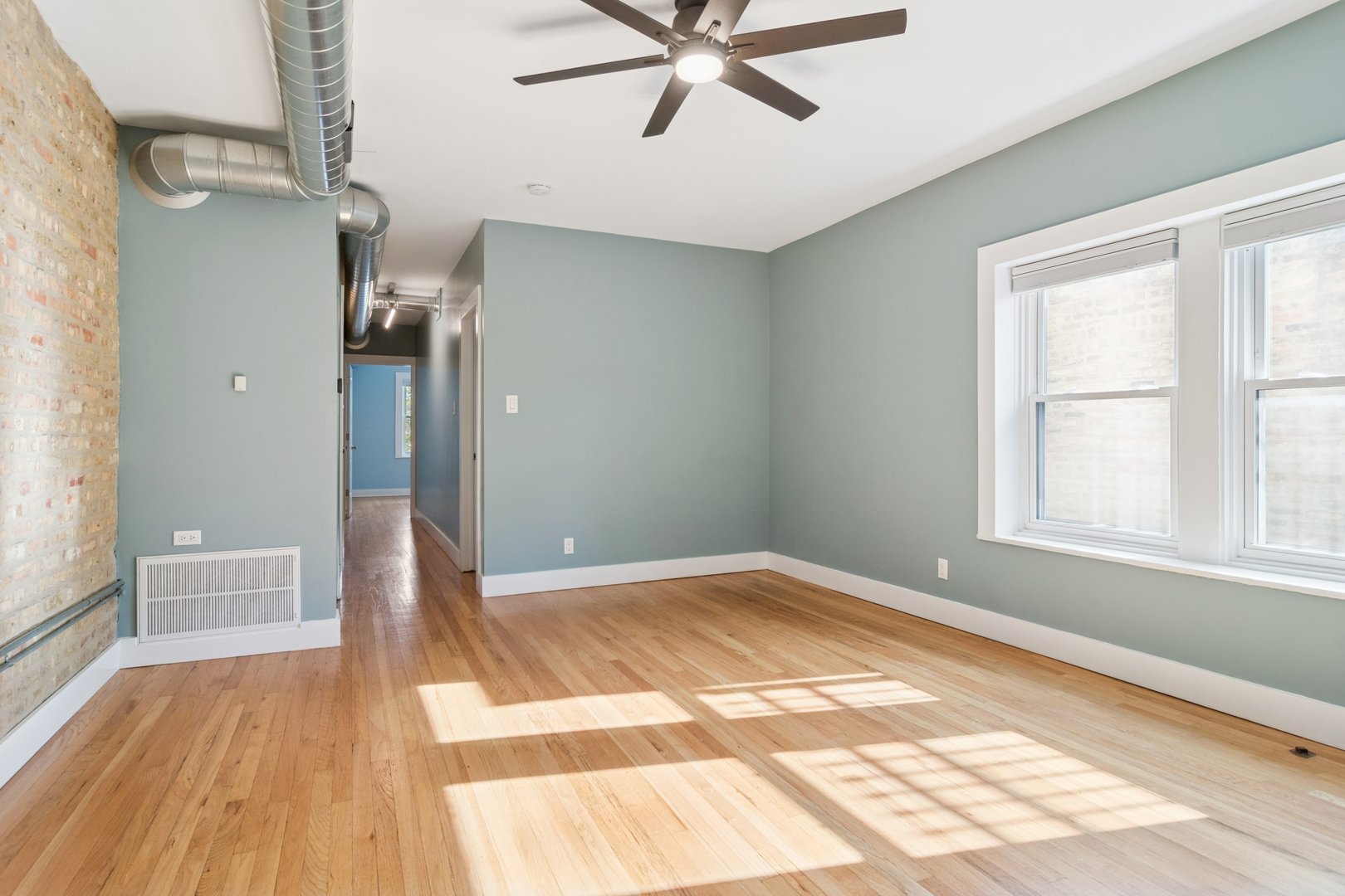 6232 North Broadway, Unit 2 Chicago, IL 60660 - Photo 9 of 22 a view of empty room with wooden floor and fan