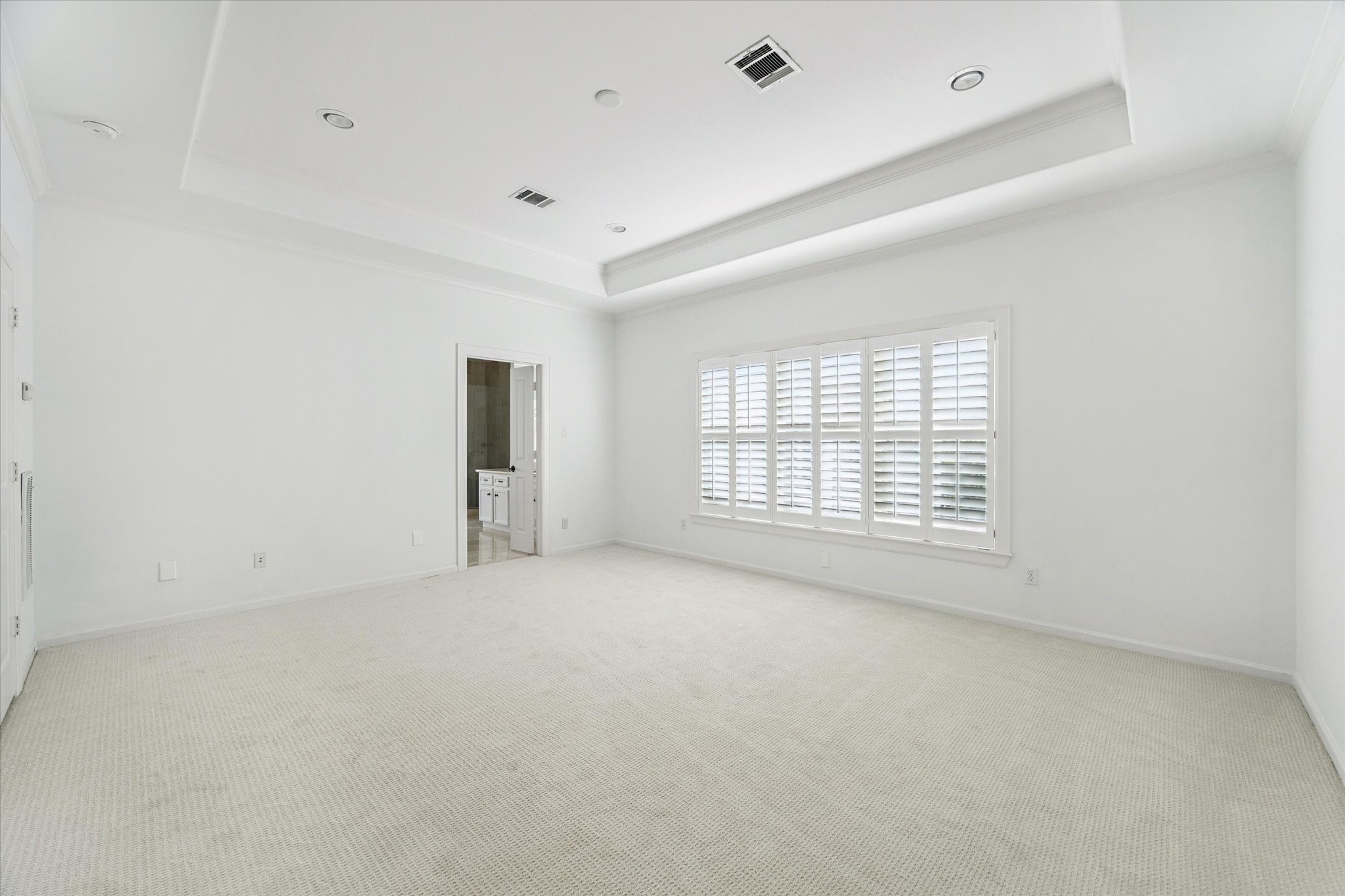 6106 Fordham Street Houston, TX 77005 - Photo 16 of 33 Another view of the generous primary suite highlights its spacious layout and connection to the luxurious en-suite bath beyond.