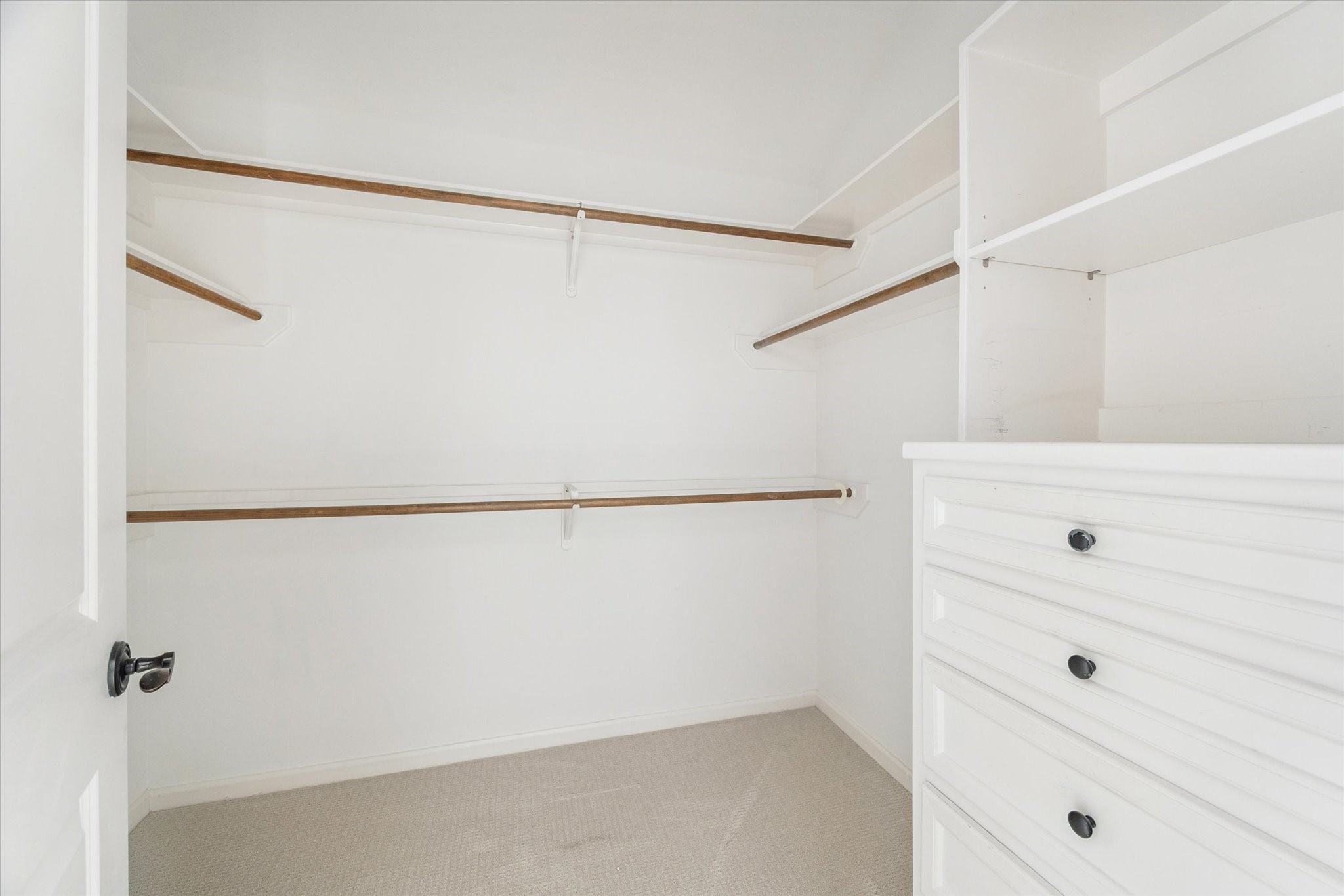 6106 Fordham Street Houston, TX 77005 - Photo 20 of 33 Secondary primary walk-in closet with built-in drawers, shelving, and ample hanging space—designed for efficient storage and everyday convenience.
