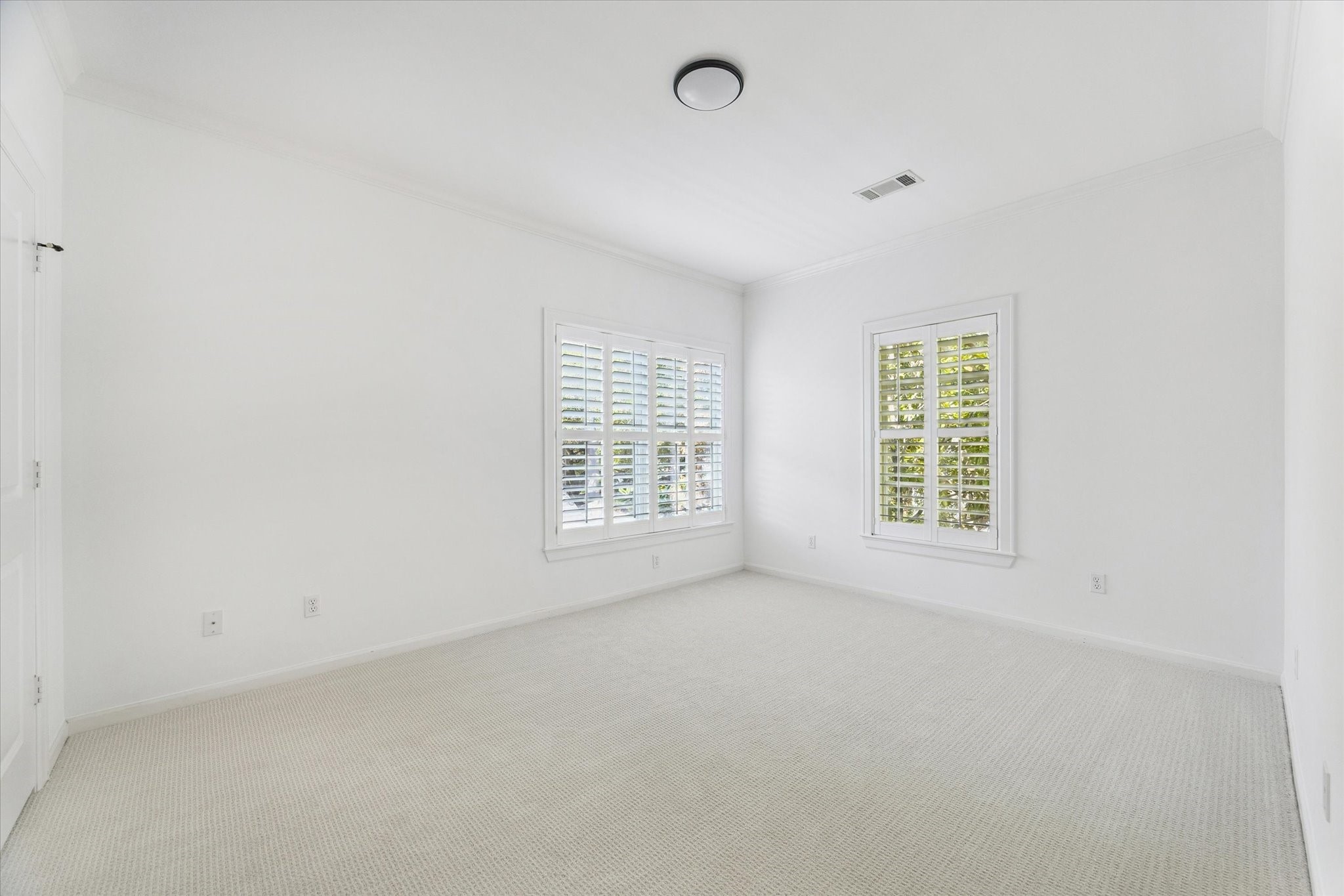 6106 Fordham Street Houston, TX 77005 - Photo 22 of 33 Light and bright secondary bedroom featuring plantation shutters, neutral carpeting, and a spacious layout ideal for guests or family.