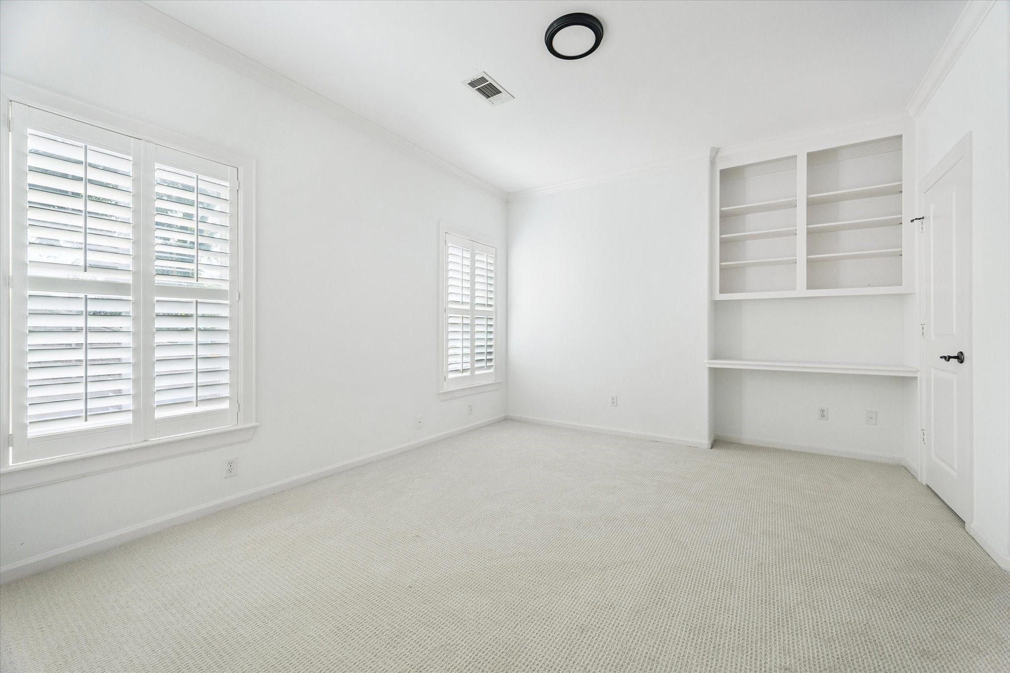 6106 Fordham Street Houston, TX 77005 - Photo 27 of 33 Versatile bedroom showcasing built-in shelving and a desk area, perfect for a study space, playroom, or creative studio.