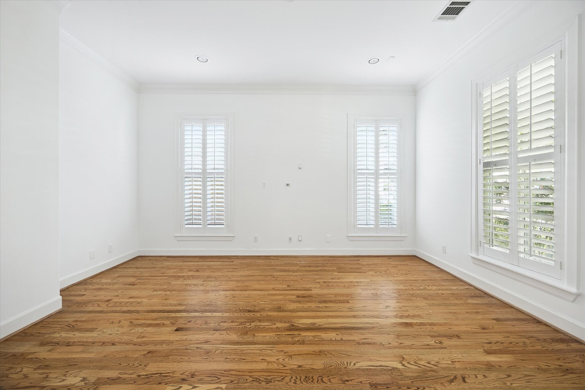 6106 Fordham Street Houston, TX 77005 - Photo 4 of 33 Spacious formal living room with hardwood floors and large windows—perfect for multiple furniture arrangements or a comfortable sitting area.