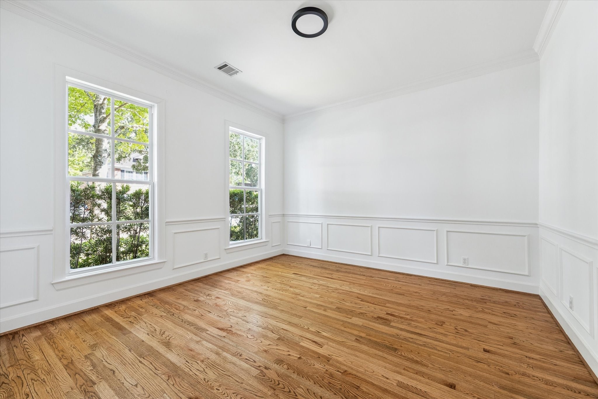 6106 Fordham Street Houston, TX 77005 - Photo 6 of 33 Elegant dining room with classic millwork, picture-frame wainscoting, and large double-hung windows overlooking the front yard.