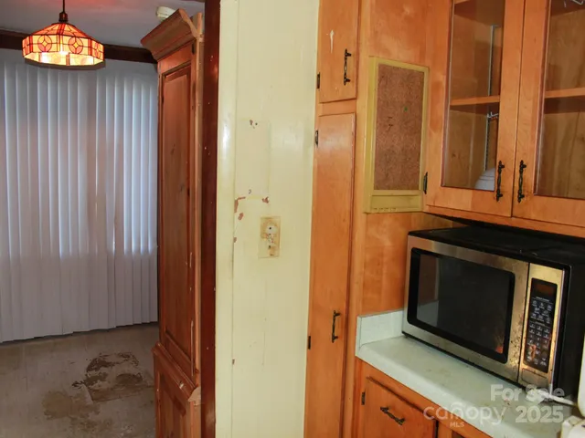 a view of an empty room with window and closet area
