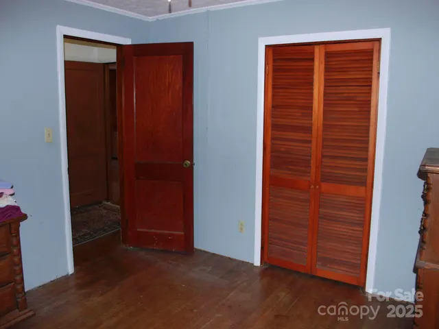a bathroom with a granite countertop toilet and a sink