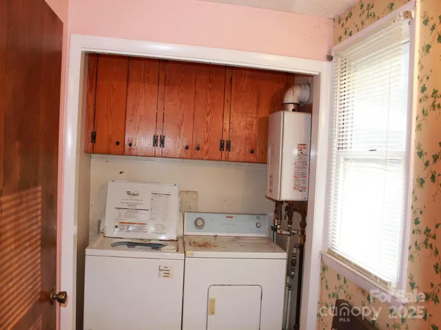 a room with a refrigerator and a window