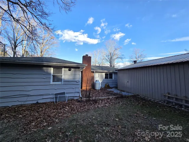 a view of backyard with car parked