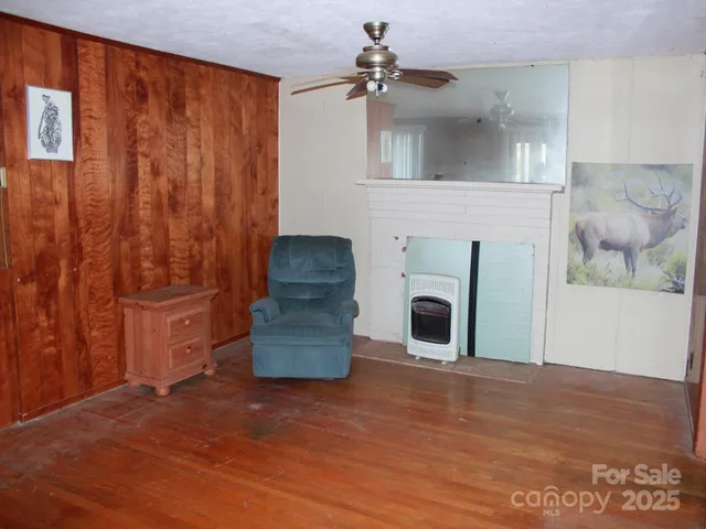 a view of a livingroom with a fireplace and cabinet