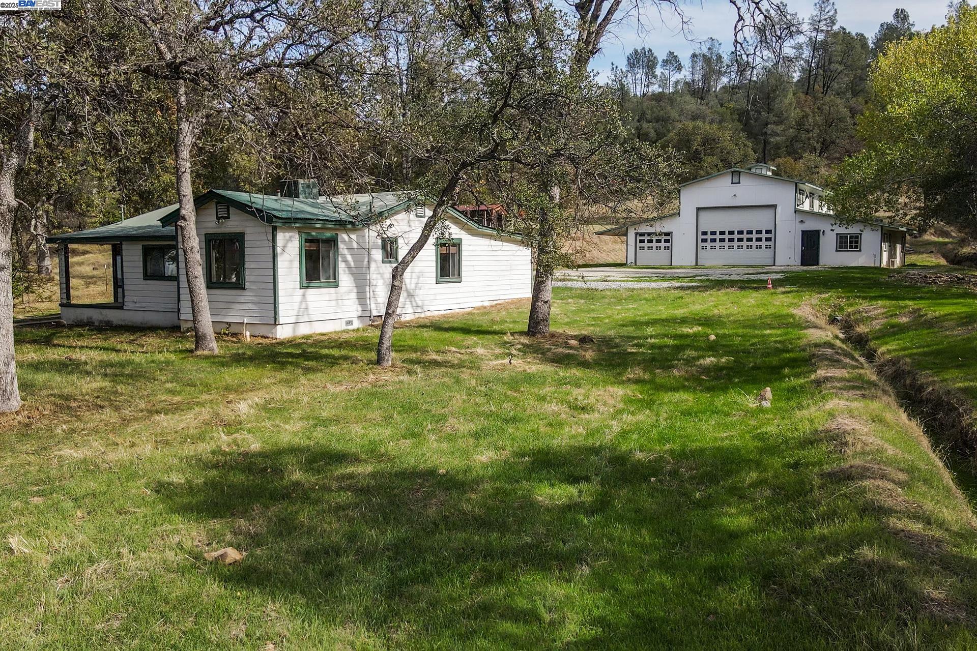 a house with green field in front of it