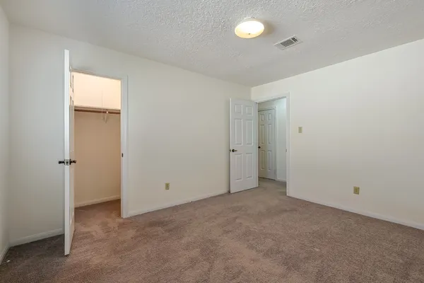 an empty room with closet area