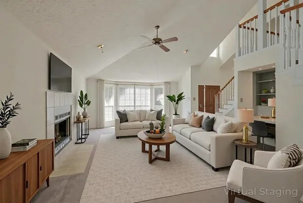 a living room with furniture and a fireplace