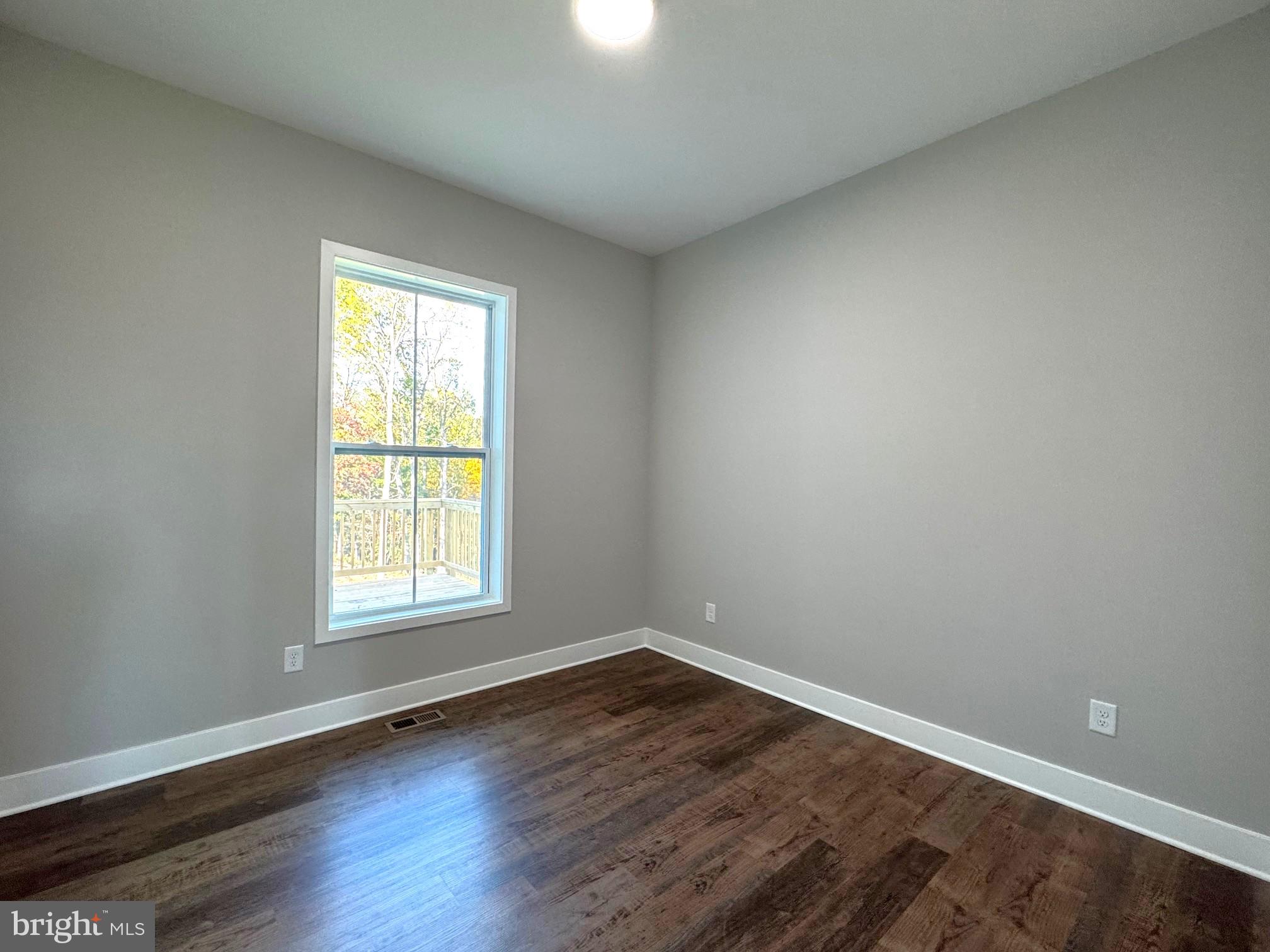 8 Glenaire Road Bunker Hill, WV 25413 - Photo 11 of 17 an empty room with wooden floor and windows