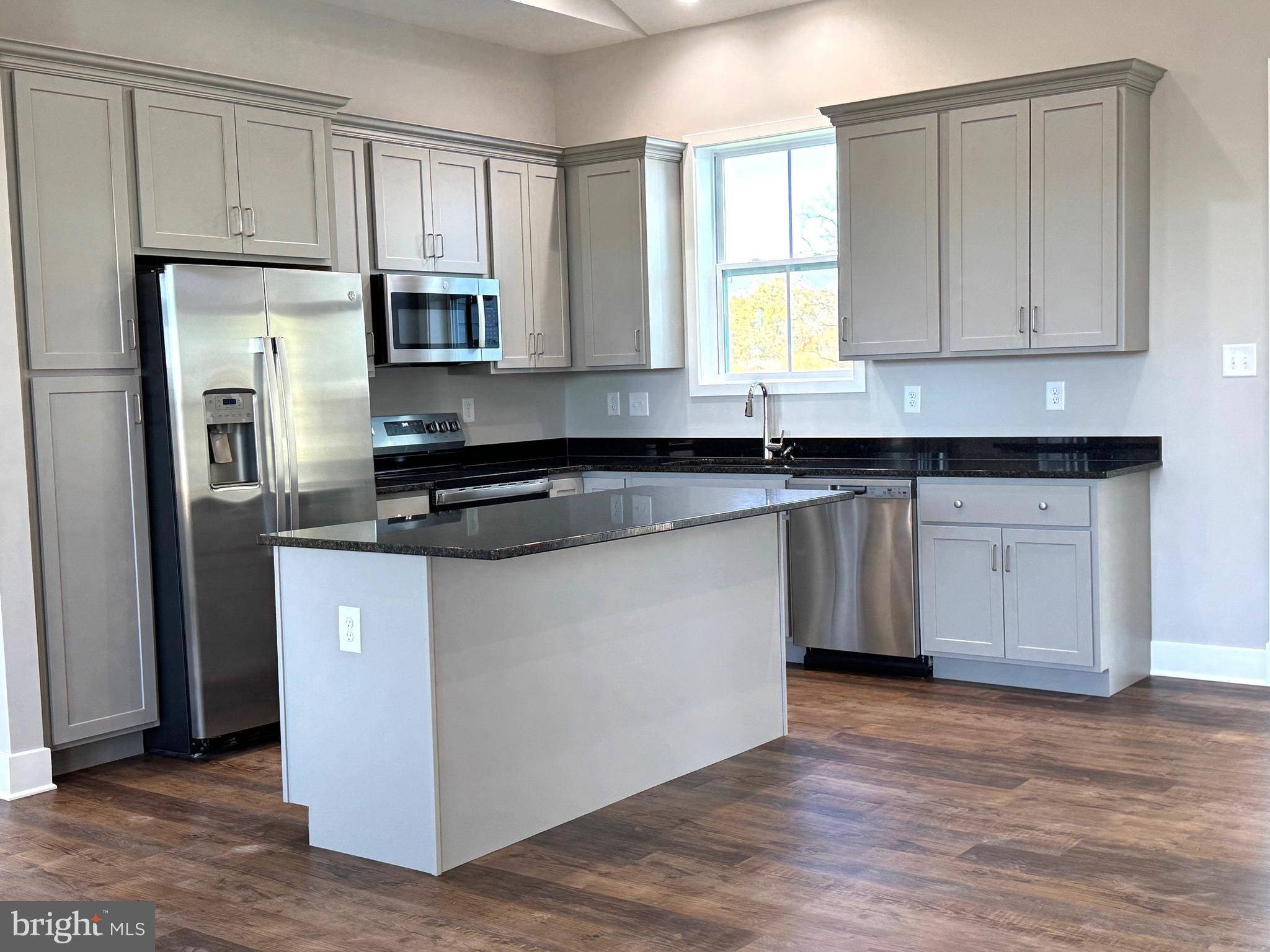 8 Glenaire Road Bunker Hill, WV 25413 - Photo 3 of 17 a kitchen with stainless steel appliances granite countertop a stove a sink and a refrigerator
