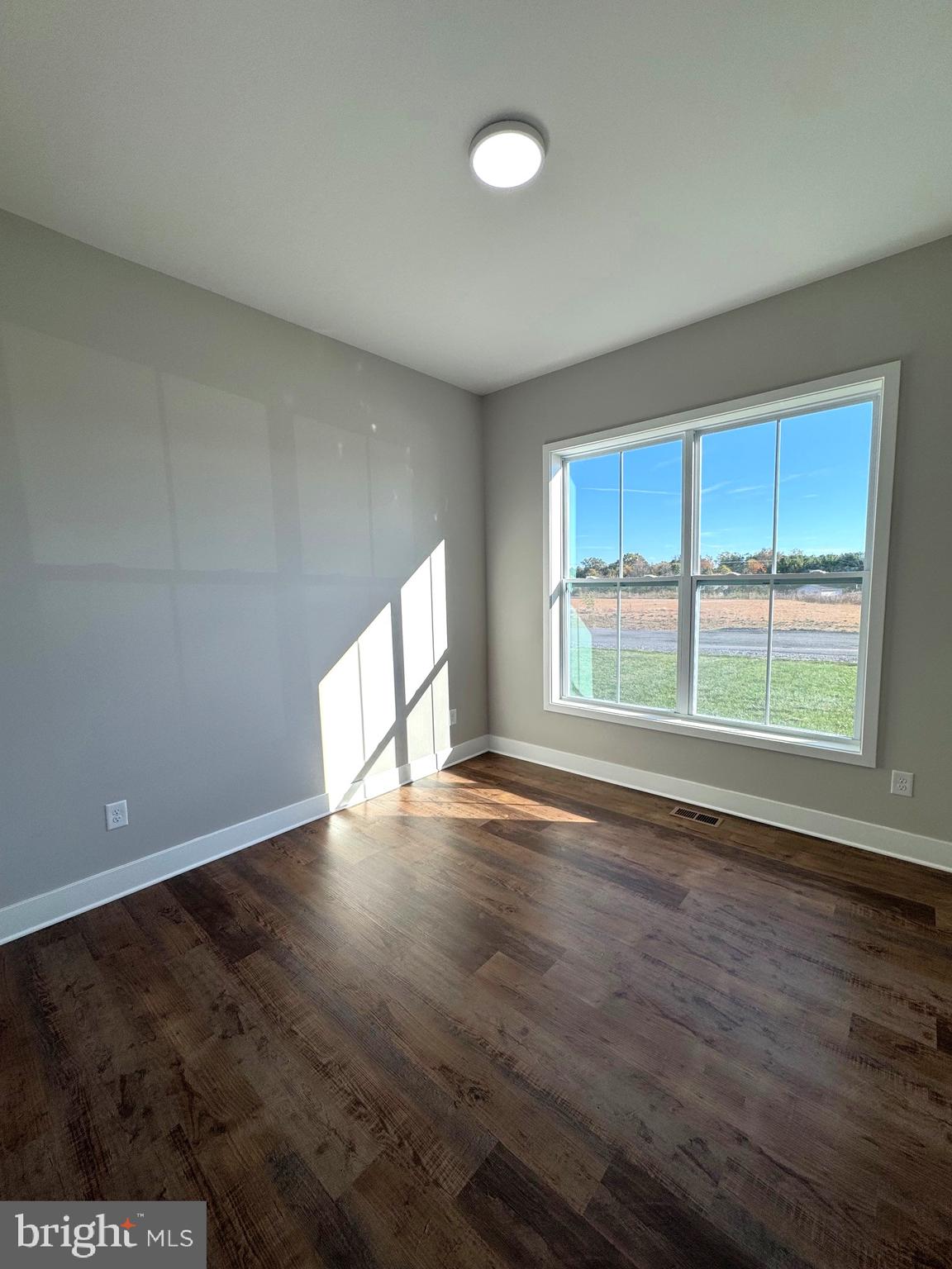 8 Glenaire Road Bunker Hill, WV 25413 - Photo 9 of 17 wooden floor in an empty room with a window