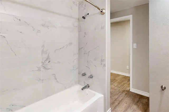 a bathroom with a bathtub and a shower