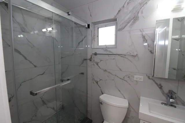 a bathroom with a toilet and a shower