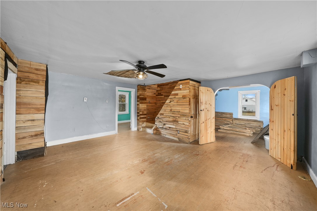 14080 Nash Road Burton, OH 44021 - Photo 6 of 49 Unfurnished living room featuring ceiling fan and wood walls