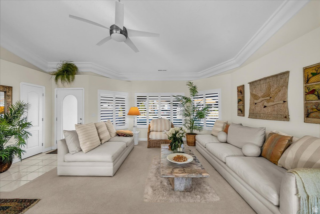150 South Crystal Street, Unit 31 St. George, UT 84770 - Photo 7 of 20 Carpeted living area featuring ceiling fan, a tray ceiling, and tile patterned flooring