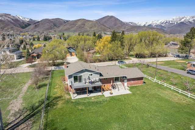 550 Pine Canyon Road Midway, UT 84049 - Photo 42 of 44 Rear exterior featuring a multi-level deck, lower patio, and a spacious green lawn