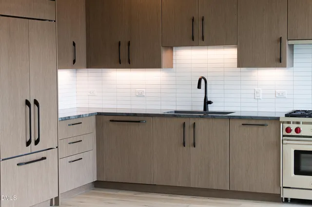 a stove top oven sitting inside of a kitchen