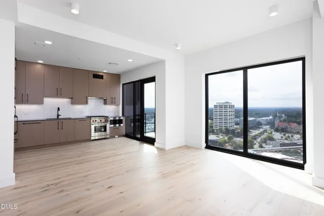 a kitchen with granite countertop a stove sink and cabinets