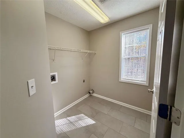 a view of a room with rack on the wall and a window