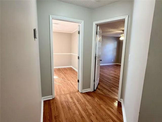 a view of a hallway with wooden floor