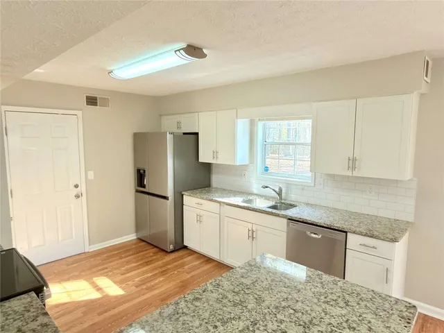 a kitchen with a sink stove and refrigerator