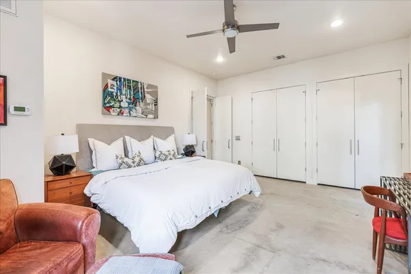 a spacious bedroom with a bed and a couch
