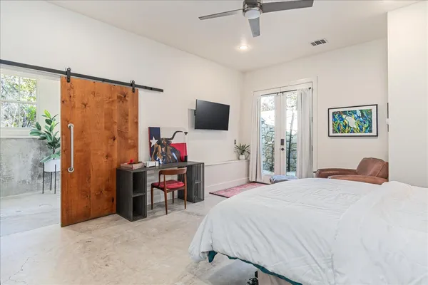 a bedroom with a bed and a flat tv screen