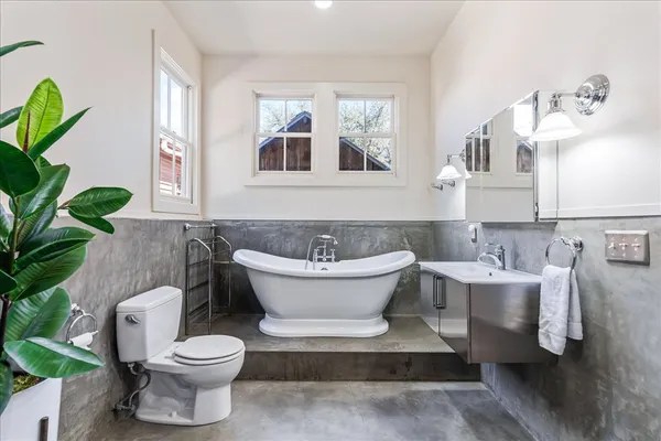 a bathroom with a white toilet a sink and a bathtub