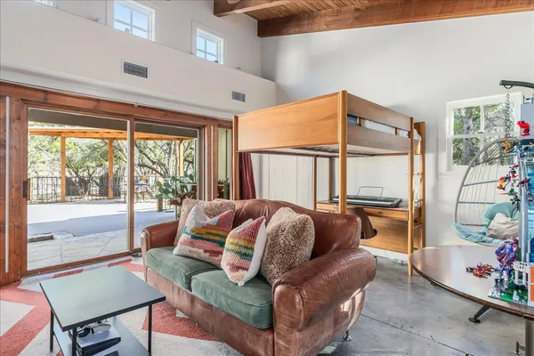 a living room with furniture and a floor to ceiling window