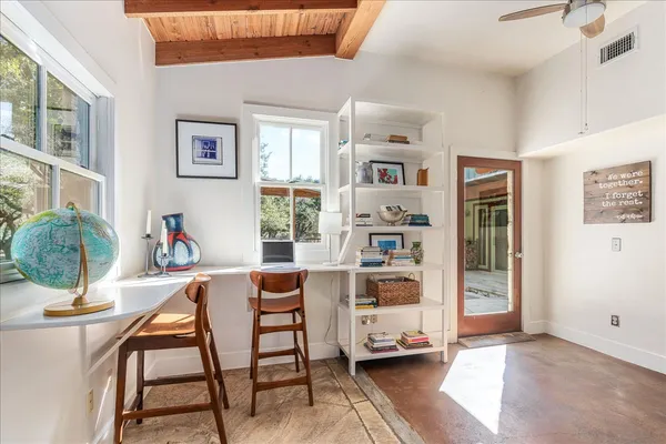 a workspace with furniture and window