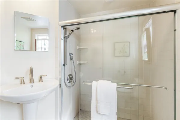 a bathroom with a shower and a sink