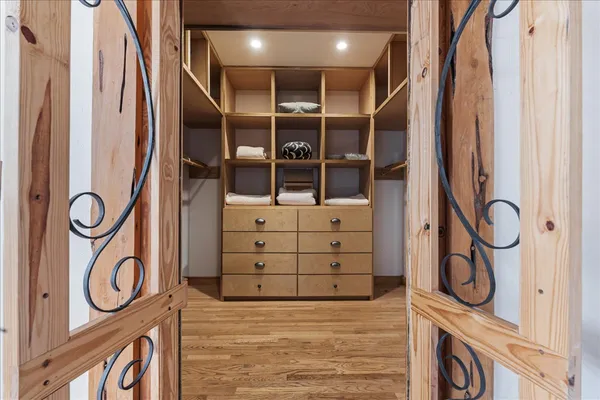 a view of walk in closet with clothes