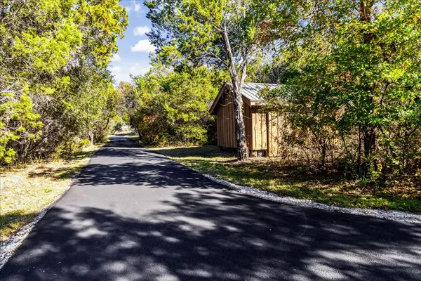 a view of a pathway with a yard