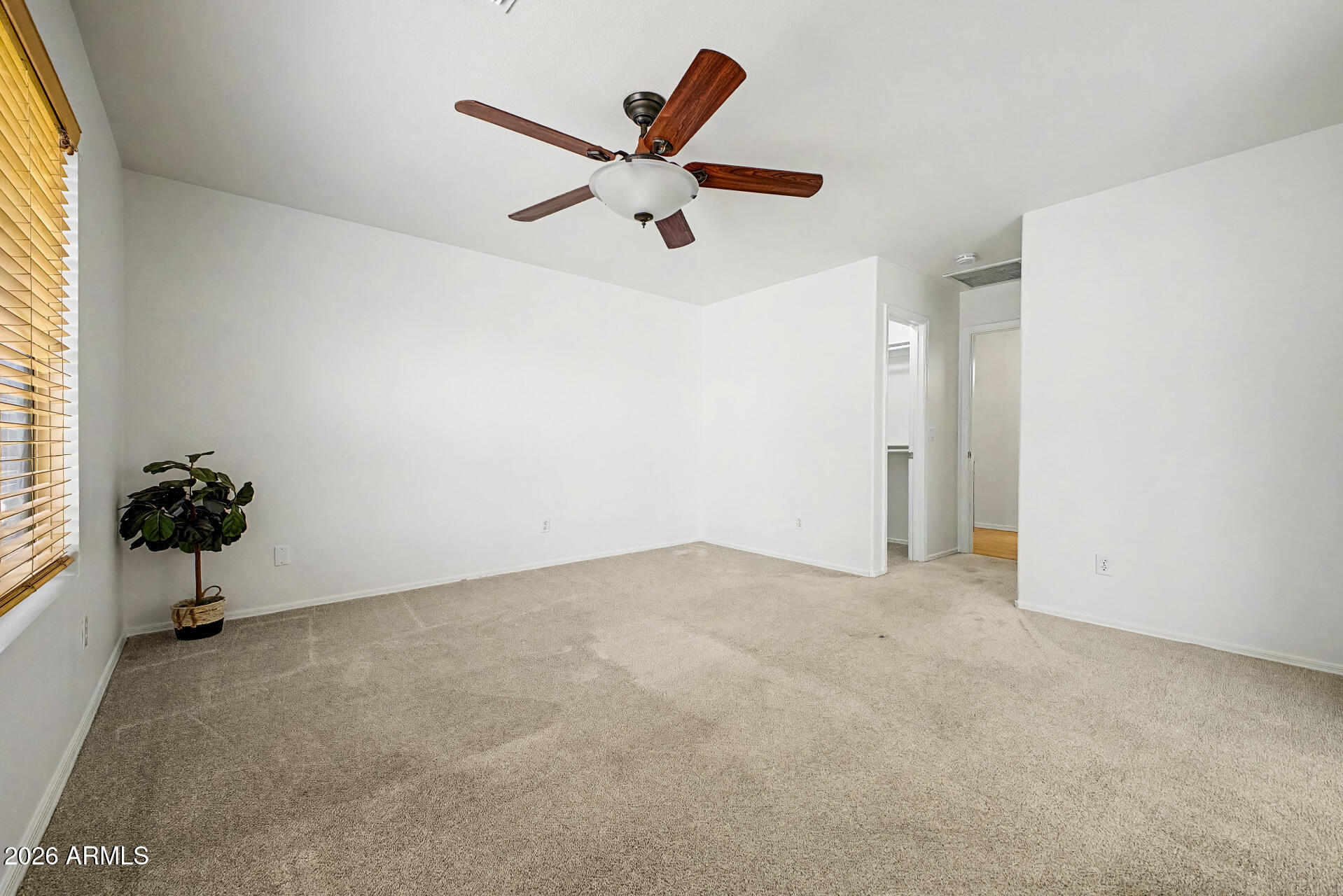 2762 North Ricardo Mesa, AZ 85215 - Photo 23 of 38 an empty room with a potted plant and a ceiling fan