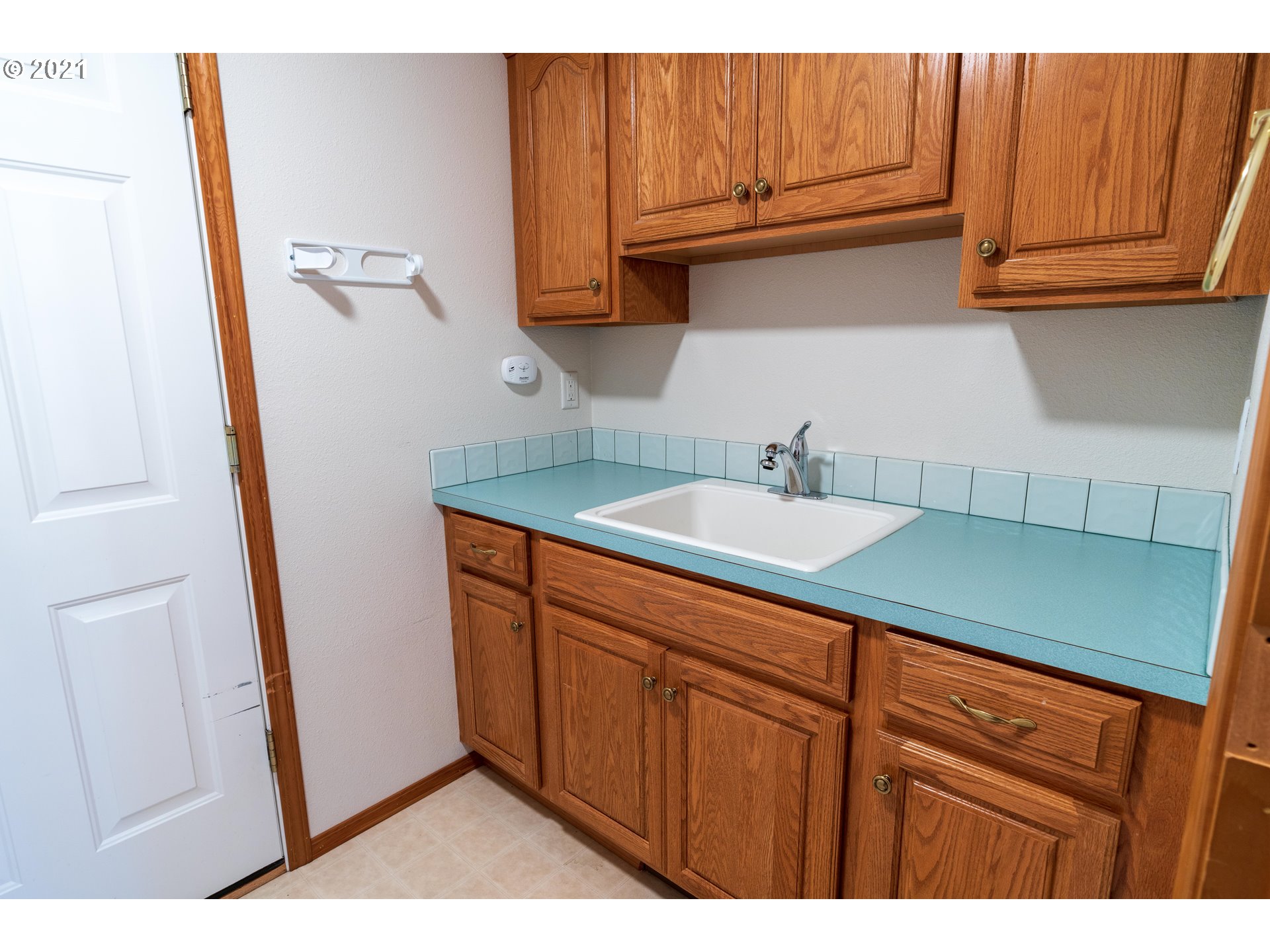 3305 Falcon Drive Springfield, OR 97477 - Photo 23 of 26 a kitchen with a sink and cabinets